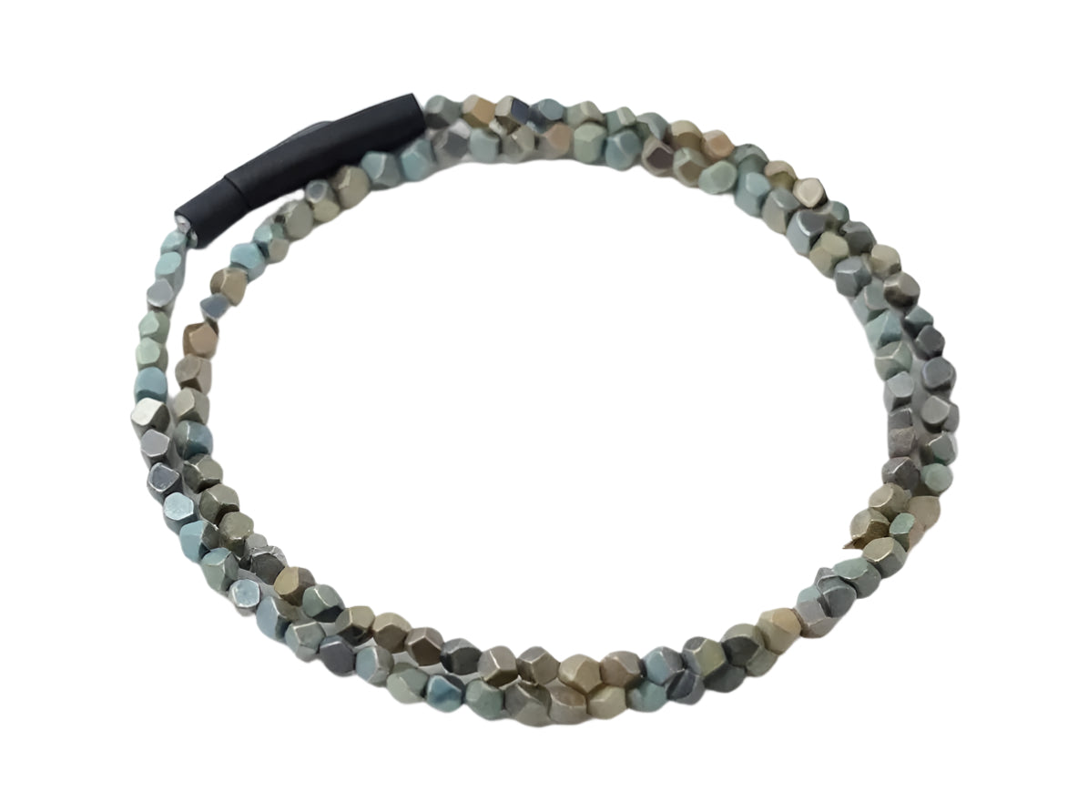 Beaded necklace with a black clasp on a white background